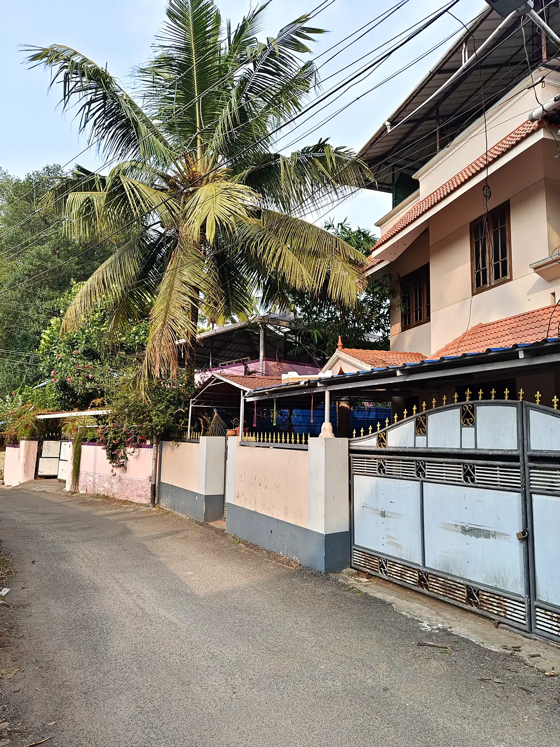The quiet residential lane outside the house in Vazhottukonam